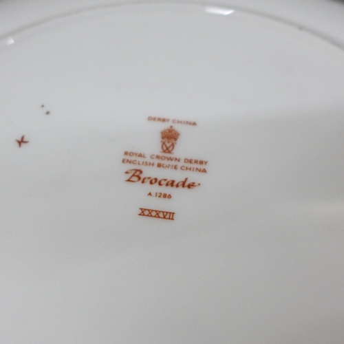 2099 - Two Royal Crown Derby plates, a magnifying glass and letter opener in a wooden box and a cased set o... 