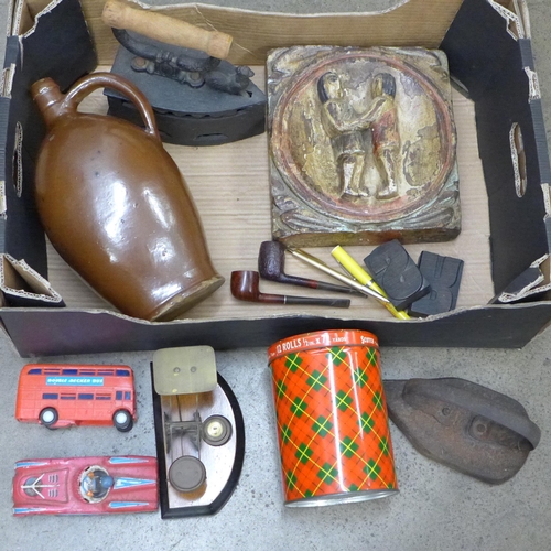 2376 - A continental polychrome wood relief, two flat irons, Victorian brass postal balance, salt glazed br... 