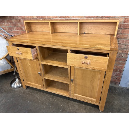 3170 - A solid oak reception desk with storage shelves (slight damage and a splinter on the left door) *Thi... 