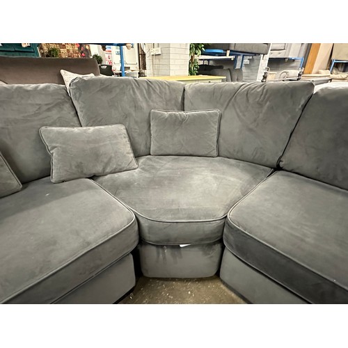 3107 - A steel velvet upholstered corner sofa