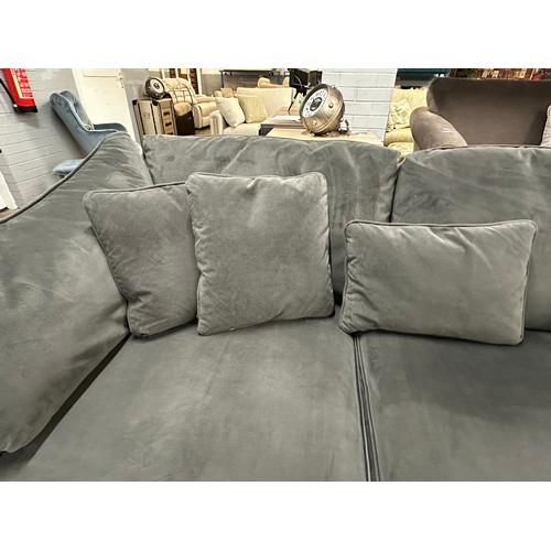 3107 - A steel velvet upholstered corner sofa