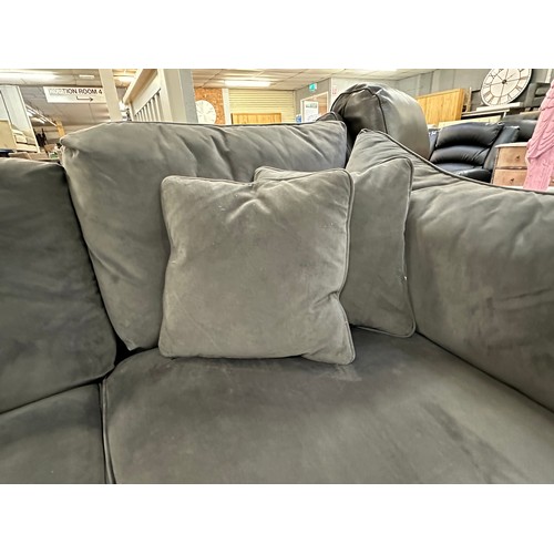 3107 - A steel velvet upholstered corner sofa