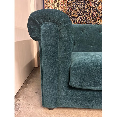 3034 - A Castleton green velvet three seater sofa