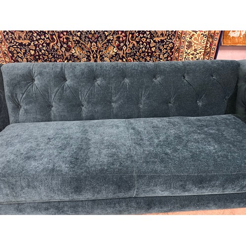 3034 - A Castleton green velvet three seater sofa