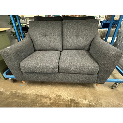 3115 - A dark static grey upholstered compact two seater sofa on turned oak legs