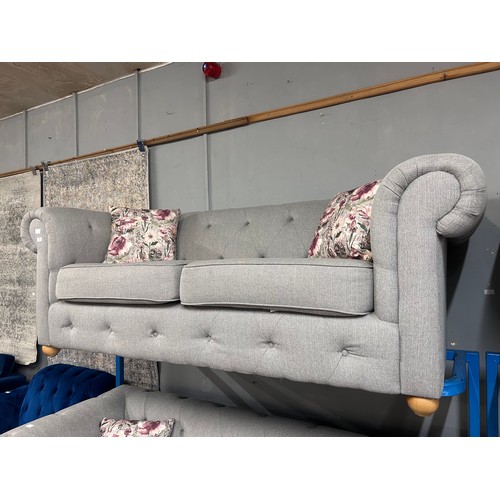 3043 - A grey upholstered Chesterfield three seater sofa