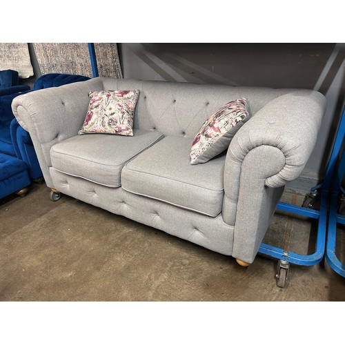 3042 - A grey upholstered Chesterfield two seater sofa