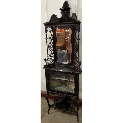 125 - An Edward VII carved ebonised freestanding corner cabinet