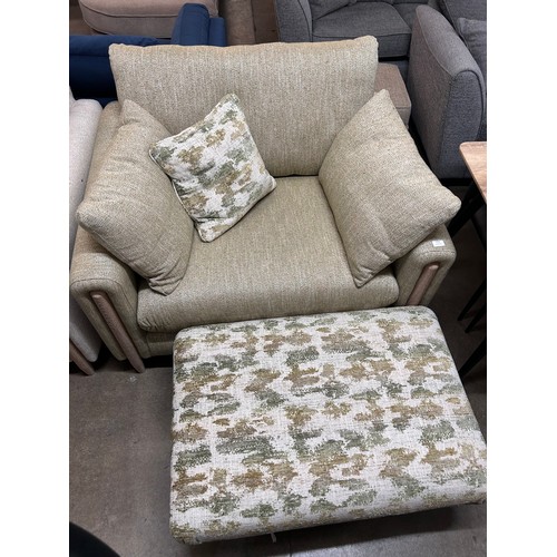 3059 - An ivory two seater sofa, an olive green armchair and footstool on a semi exposed frame