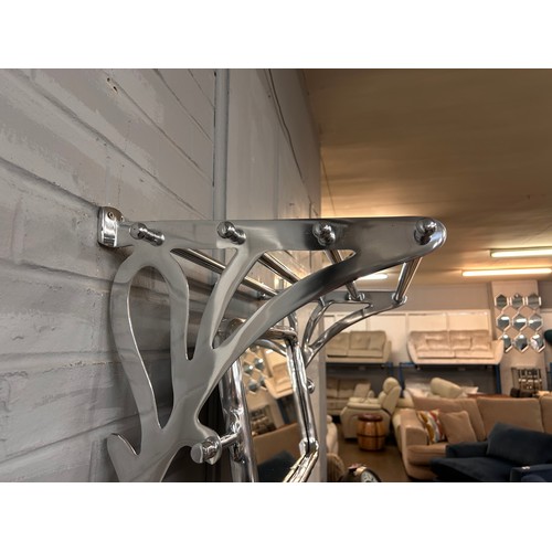 3064 - A chrome wall mounted luggage rack