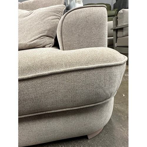 3147 - A beech beige upholstered 2.5 seater sofa on light oak legs, tear to inside of cushion