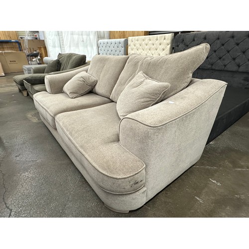 3147 - A beech beige upholstered 2.5 seater sofa on light oak legs, tear to inside of cushion