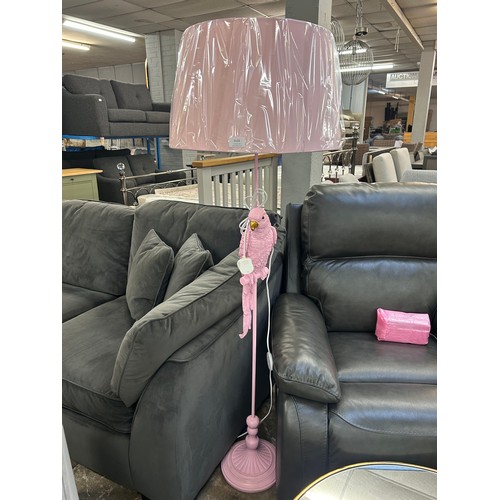 3133 - A bubblegum pink floor standing parrot lamp