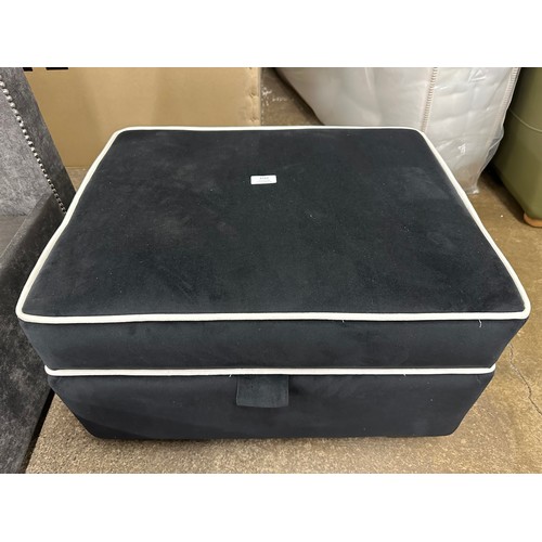 3152 - A black velvet upholstered ottoman footstool with white piping