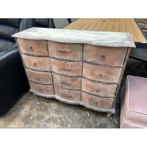 3137 - A distressed heavy hardwood twelve drawer chest