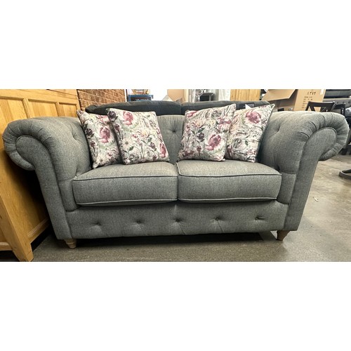 3168 - A dark grey upholstered textured weave two seater Chesterfield sofa with patterned scatter cushions