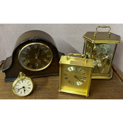 234 - An early 20th Century oak mantle clock, a brass anniversary clock and two others