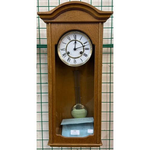 249 - An oak cased Hermle wall clock