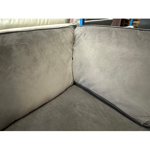 3195 - A mauve velvet upholstered large corner sofa (slight rip)