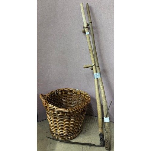 259 - A wicker log basket, a scythe and a scythe handle