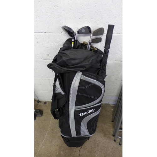 5177 - A Dunlop golf bag with umbrella, putter, driver and 3 other clubs