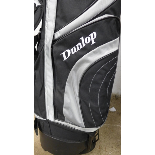 5177 - A Dunlop golf bag with umbrella, putter, driver and 3 other clubs