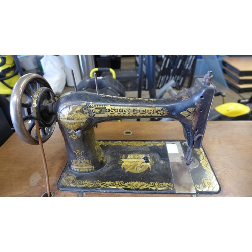 5185 - A vintage belt driven Singer sewing machine (11812352) mounted to a cast metal Singer sewing table