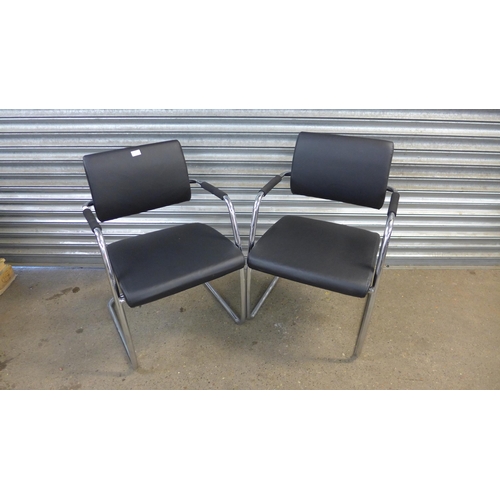 5187 - A pair of chrome and black leather effect padded armchairs