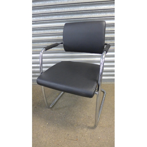 5187 - A pair of chrome and black leather effect padded armchairs