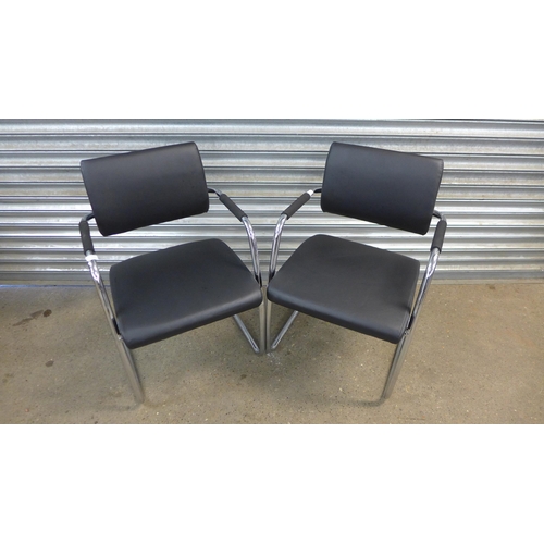 5189 - A pair of chrome and black leather effect padded armchairs