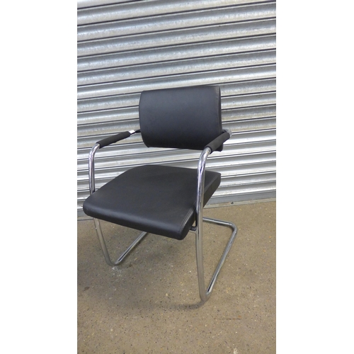 5189 - A pair of chrome and black leather effect padded armchairs