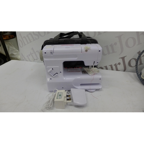 5210 - A Tefal Pro Express Ultimate Steam Generator iron and a Sew Land model SM402 electric sewing machine... 