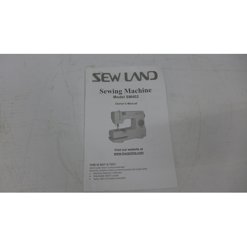 5210 - A Tefal Pro Express Ultimate Steam Generator iron and a Sew Land model SM402 electric sewing machine... 