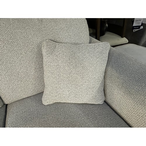 3211 - An ivory textured weave upholstered two seater sofa