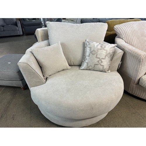 3217 - An ivory upholstered swivel chair (damage on the right arm)