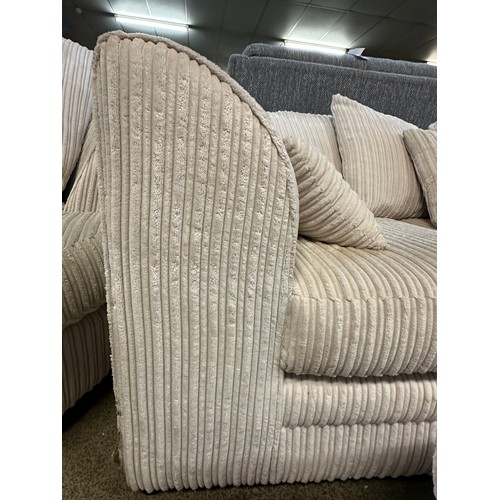 3218 - An ivory jumbo cord upholstered compact corner sofa and footstool