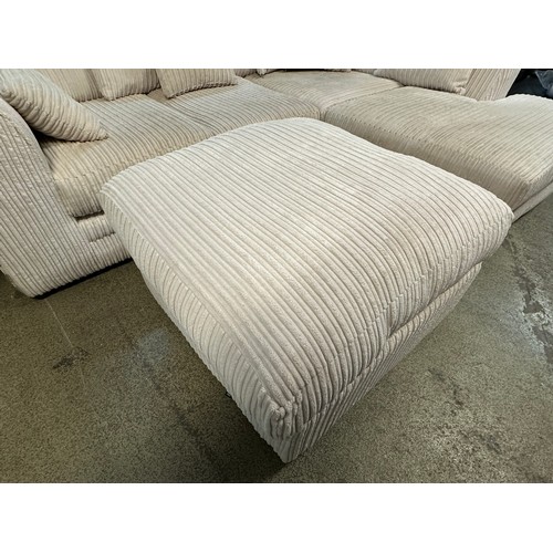 3218 - An ivory jumbo cord upholstered compact corner sofa and footstool