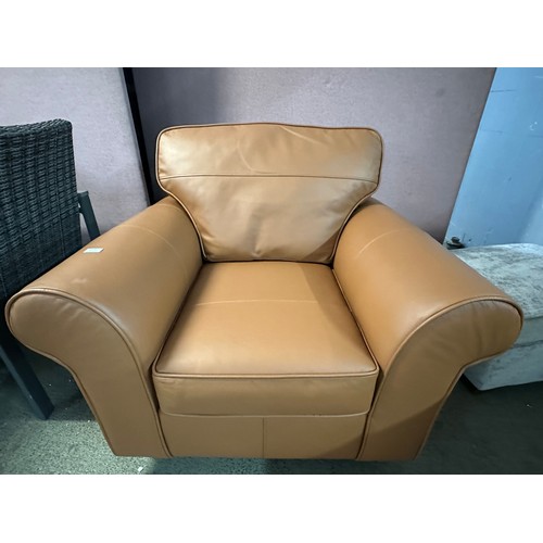 3240 - A tan leather armchair