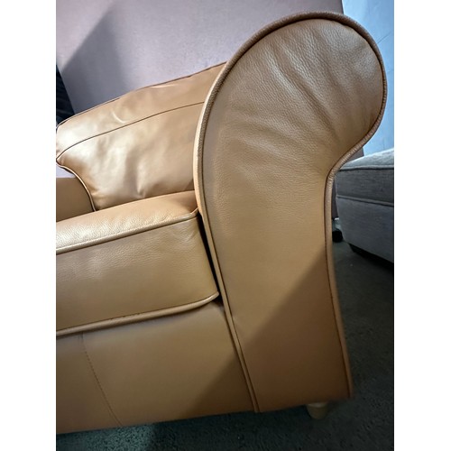 3240 - A tan leather armchair