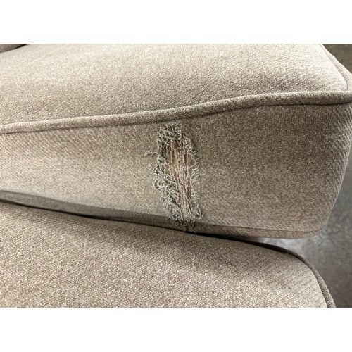 3147 - A beech beige upholstered 2.5 seater sofa on light oak legs, tear to inside of cushion