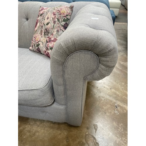 3046B - A grey textured weave upholstered Chesterfield three seater sofa bed with patterned scatter cushions