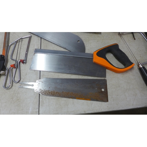 5022F - A quantity of assorted hand saws including Sandvik, an axe and hedge knife