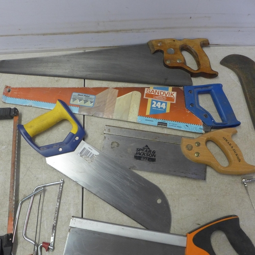 5022F - A quantity of assorted hand saws including Sandvik, an axe and hedge knife