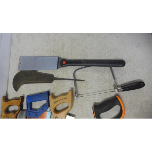 5022F - A quantity of assorted hand saws including Sandvik, an axe and hedge knife