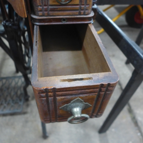 5185 - A vintage belt driven Singer sewing machine (11812352) mounted to a cast metal Singer sewing table