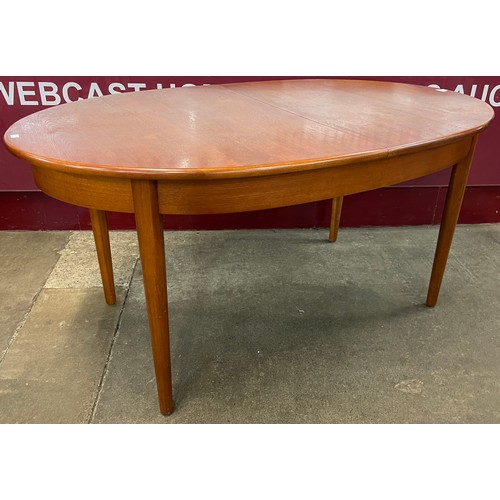 27 - A Jentique teak oval extending dining table