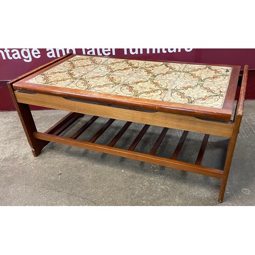 79 - A teak and tile topped coffee table