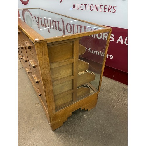 92 - An early 20th Century oak haberdashery shop counter