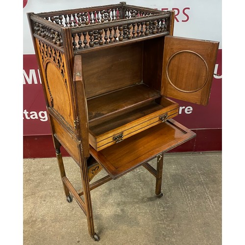 99 - A Victorian Moorish style carved walnut, double sided writing cabinet