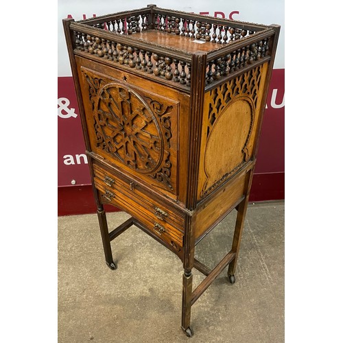 99 - A Victorian Moorish style carved walnut, double sided writing cabinet